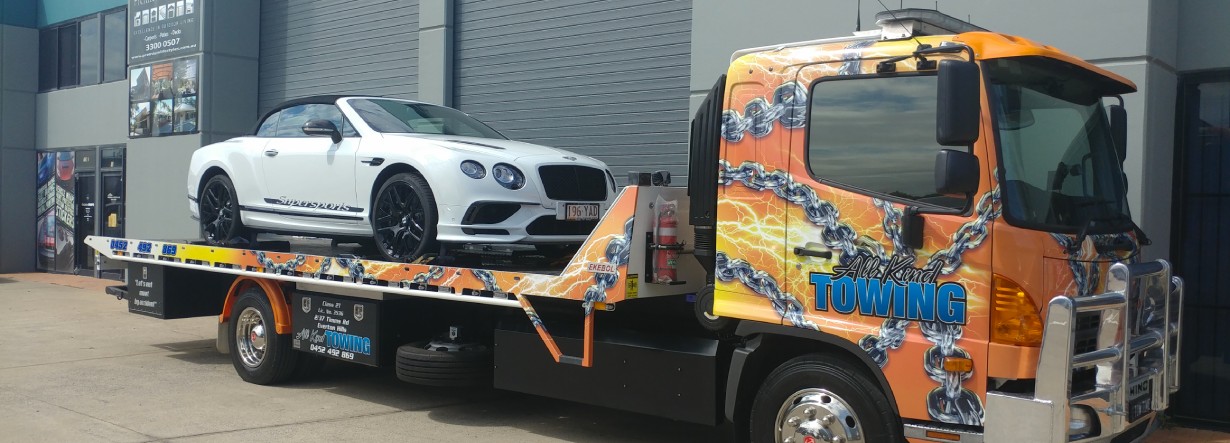 Bentley loaded on a tow truck