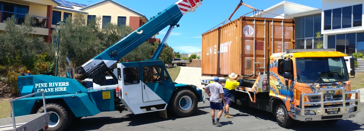 Shipping container getting loaded onto a tow truck